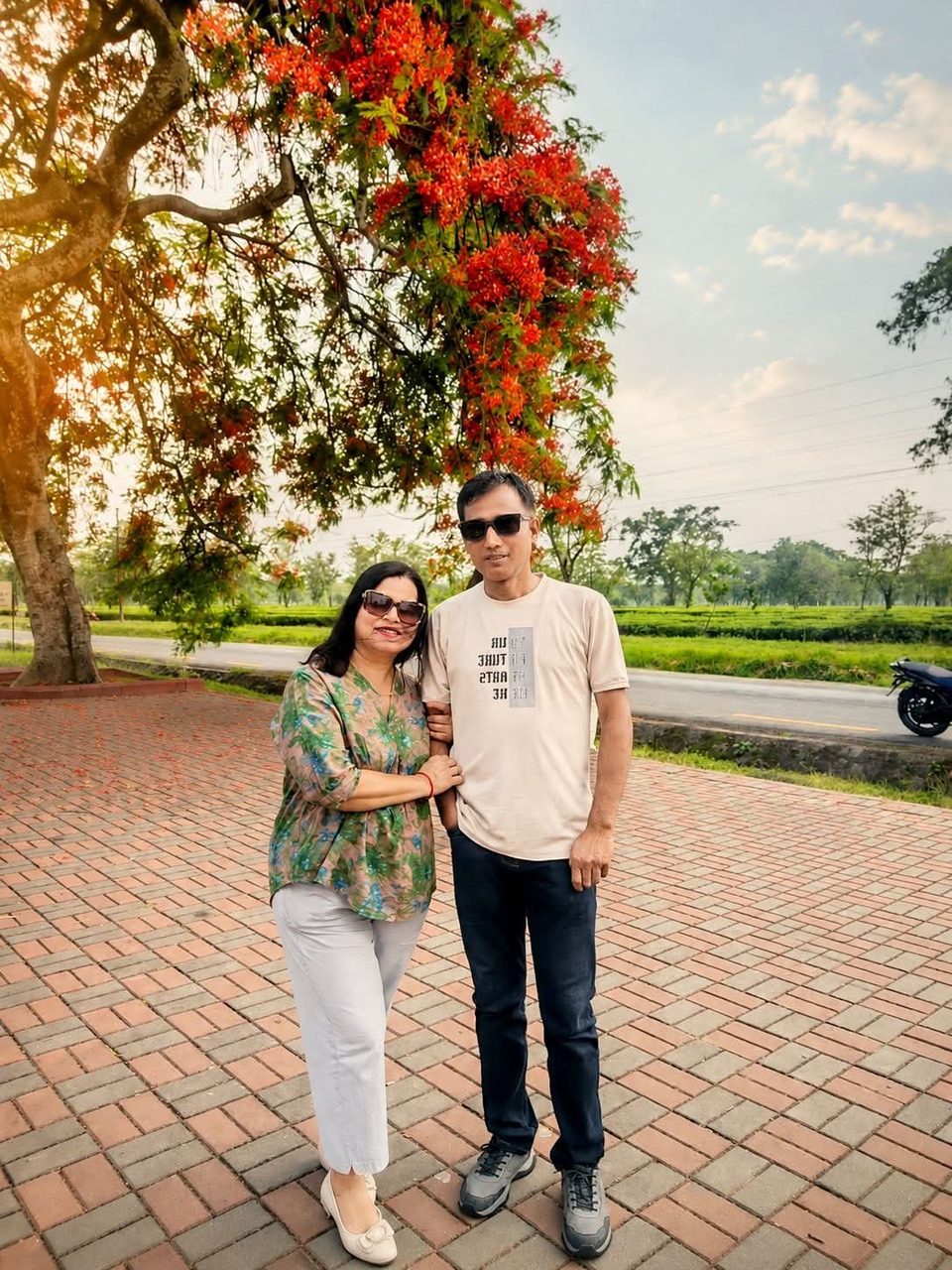 Keshaw and Indu outdoors under a tree